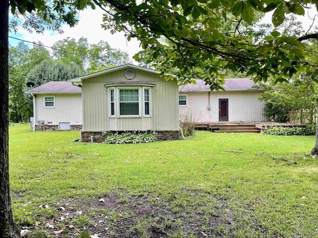  - rear view of house with a deck and a lawn