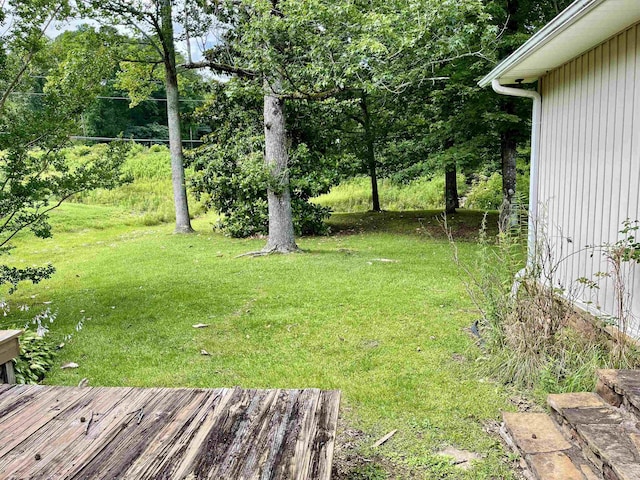  - view of green lawn with a wooden deck