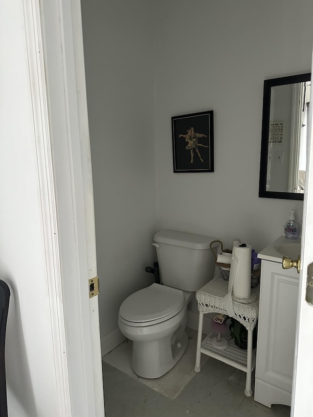 bathroom featuring tile patterned floors, vanity, and toilet