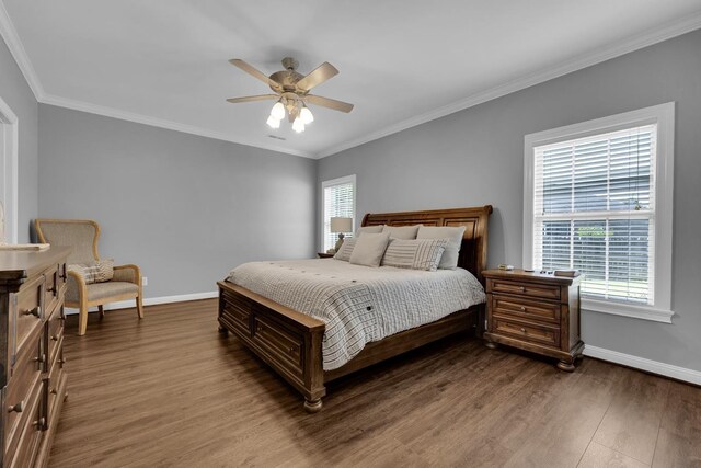  - bedroom with multiple windows, wood finished floors, crown molding, and ceiling fan