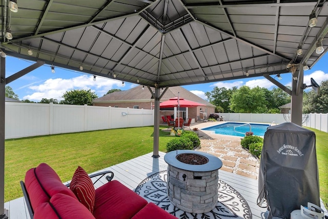  - fenced backyard with a wooden deck and a fire pit