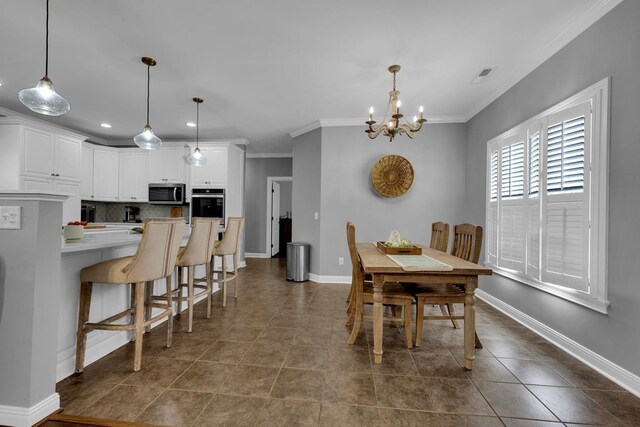  - dining space featuring a chandelier, crown molding, dark tile patterned floors, and recessed lighting