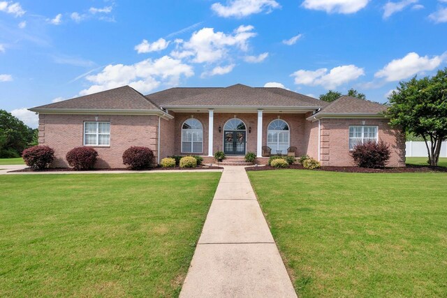  - view of front facade with french doors, a front yard, brick siding, a shingled roof, and covered porch