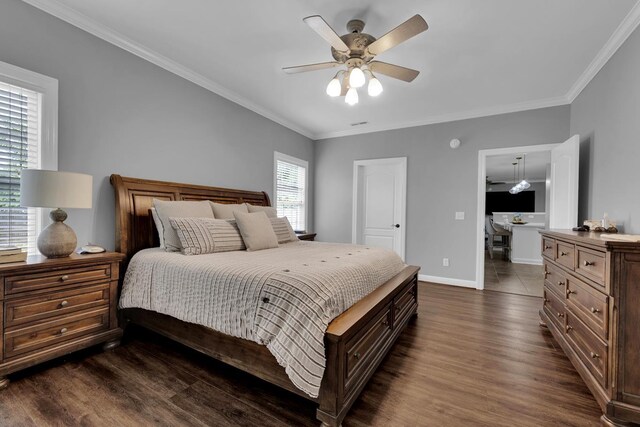  - bedroom featuring dark wood-style floors, ornamental molding, and ceiling fan