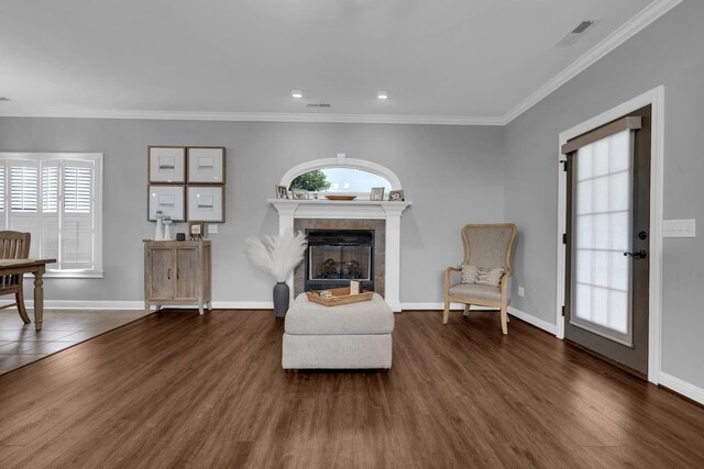  - sitting room featuring a tiled fireplace, wood finished floors, crown molding, and recessed lighting