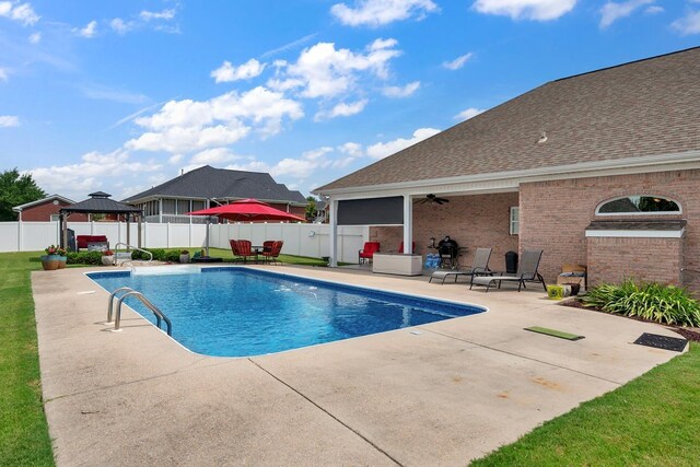  - view of swimming pool with a gazebo, a patio area, a fenced backyard, and ceiling fan