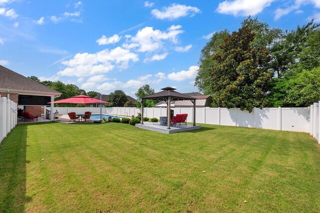  - fenced backyard with a gazebo and a patio area