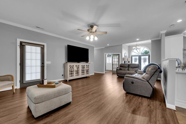  - living area featuring ceiling fan, dark wood-style floors, ornamental molding, recessed lighting, and a chandelier