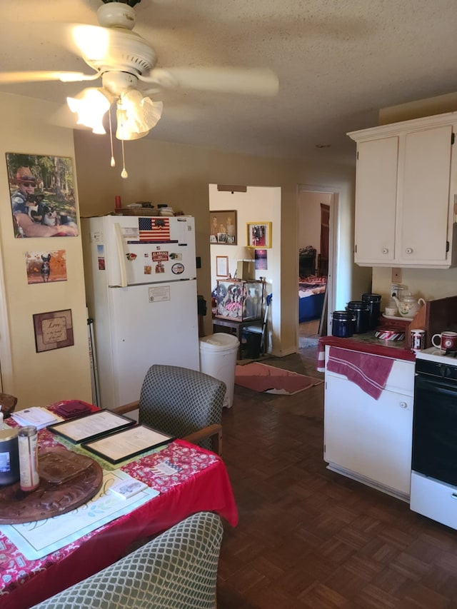 kitchen with white cabinetry, white fridge, ceiling fan, dark parquet flooring, and electric range