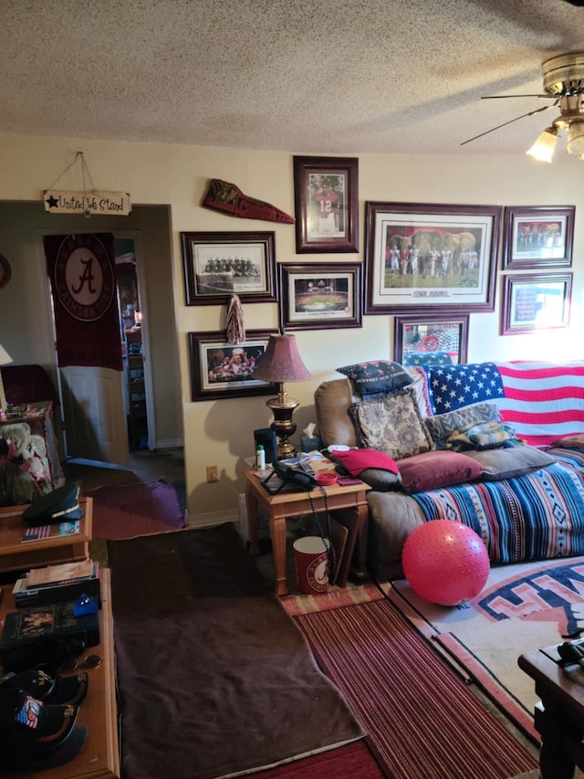 living room featuring a textured ceiling, ceiling fan, and carpet