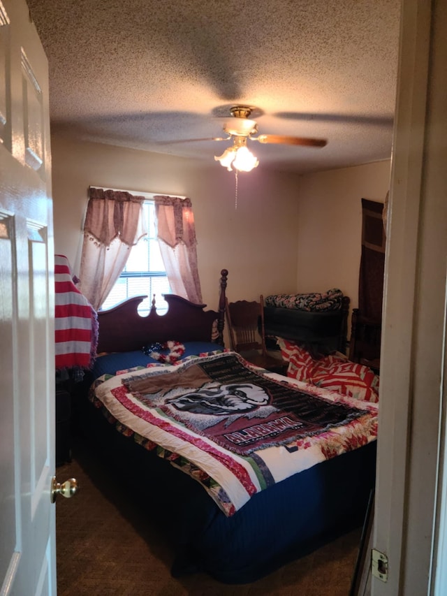 carpeted bedroom with a textured ceiling and ceiling fan