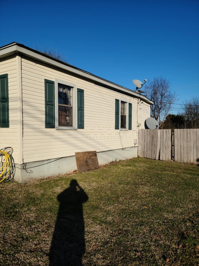 view of property exterior with a yard