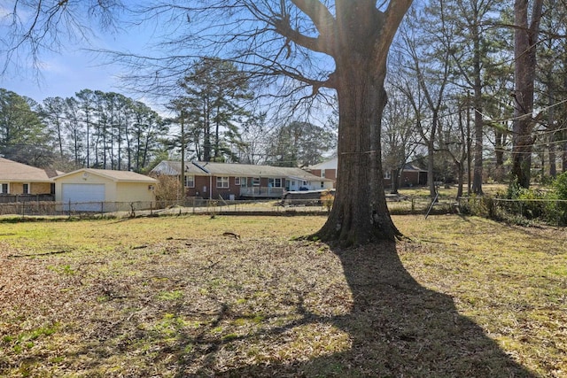 view of yard with fence and a detached garage