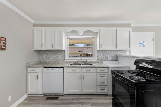 kitchen with black electric range, white dishwasher, backsplash, and a sink