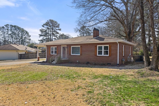 ranch-style home with a chimney, crawl space, fence, a front lawn, and brick siding