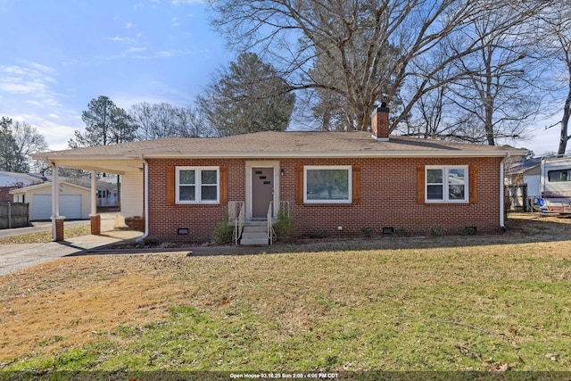 view of front of property with an attached carport, an outdoor structure, brick siding, and a front yard