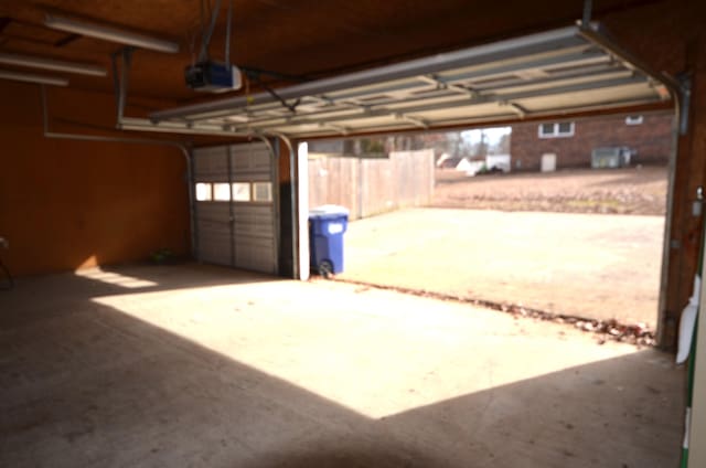 garage featuring a garage door opener and a carport