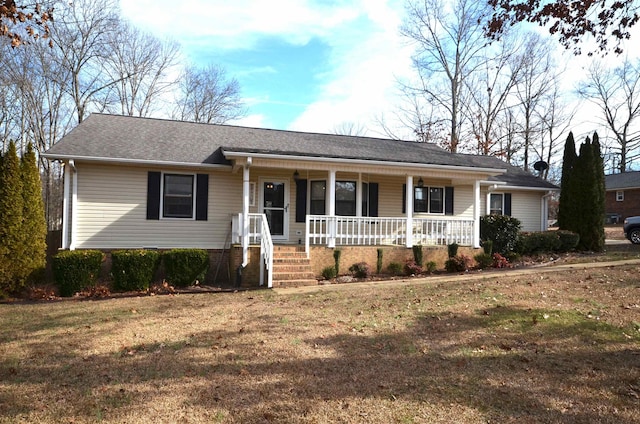 ranch-style house featuring a front lawn and covered porch