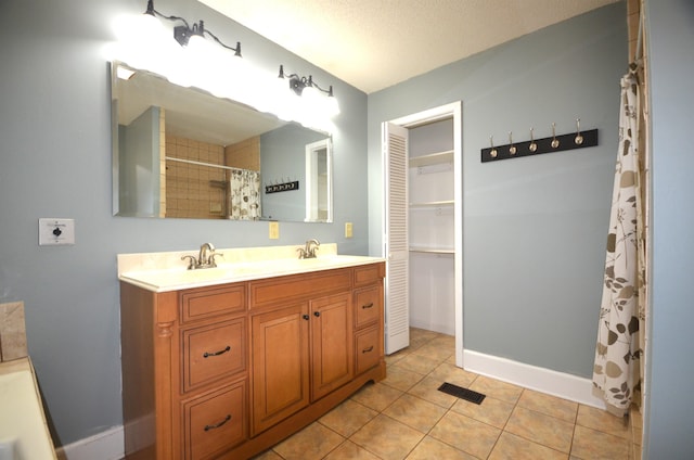 bathroom featuring vanity, tile patterned floors, a textured ceiling, and a shower with shower curtain