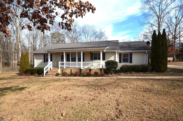 ranch-style house with a porch and a front yard