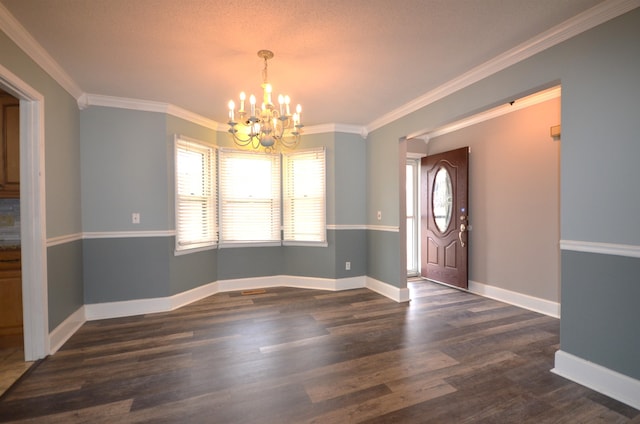 foyer with crown molding, dark hardwood / wood-style floors, and a notable chandelier