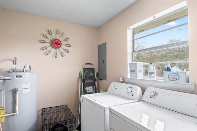 laundry room featuring washing machine and clothes dryer, electric panel, and water heater