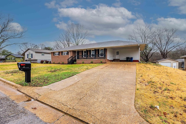 ranch-style house featuring a carport, covered porch, and a front yard