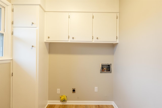 laundry room with cabinets, hookup for an electric dryer, hookup for a washing machine, and light hardwood / wood-style flooring