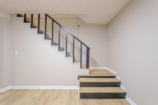 stairs featuring hardwood / wood-style flooring