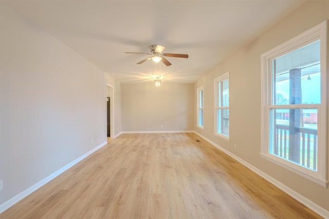 unfurnished room with plenty of natural light, light hardwood / wood-style floors, and ceiling fan