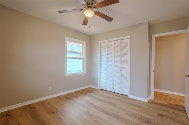 unfurnished bedroom with ceiling fan, light hardwood / wood-style floors, and a closet