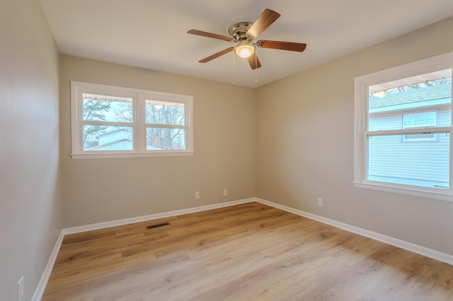 empty room featuring ceiling fan and light wood-type flooring