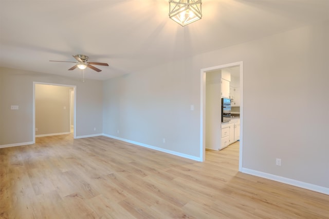 spare room with ceiling fan and light hardwood / wood-style flooring