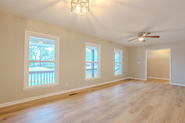 empty room with ceiling fan and light wood-type flooring