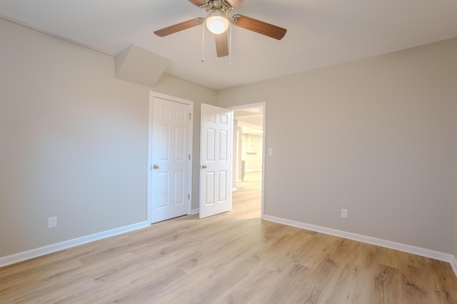 empty room with ceiling fan and light wood-type flooring