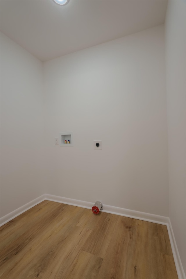 laundry area with laundry area, baseboards, light wood-type flooring, electric dryer hookup, and washer hookup