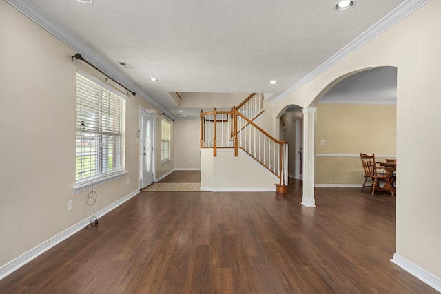 unfurnished living room featuring ornate columns, crown molding, dark hardwood / wood-style flooring, and a textured ceiling