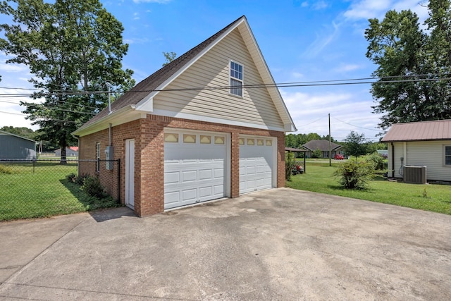 garage featuring central AC and a yard