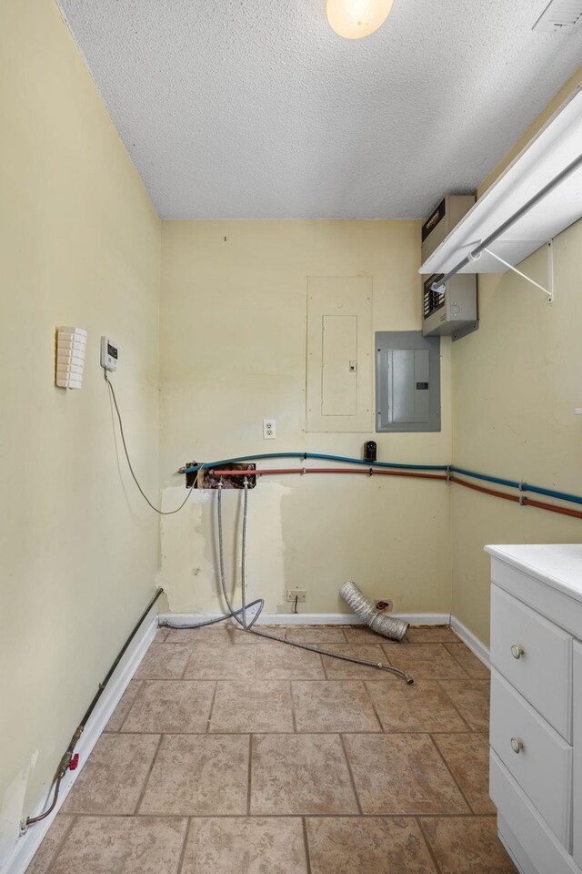 laundry room featuring a textured ceiling and electric panel