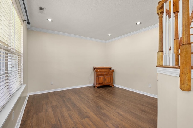 spare room with crown molding and dark wood-type flooring