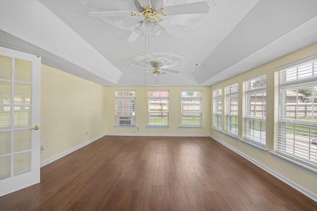 unfurnished sunroom featuring a tray ceiling