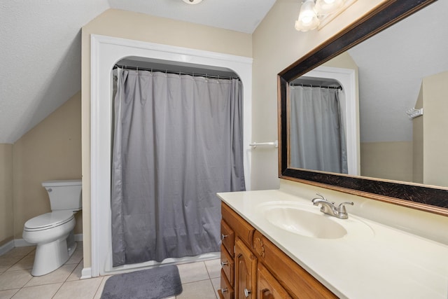 bathroom with tile patterned floors, vanity, toilet, and vaulted ceiling