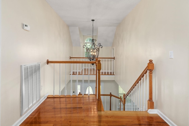 stairs featuring an inviting chandelier