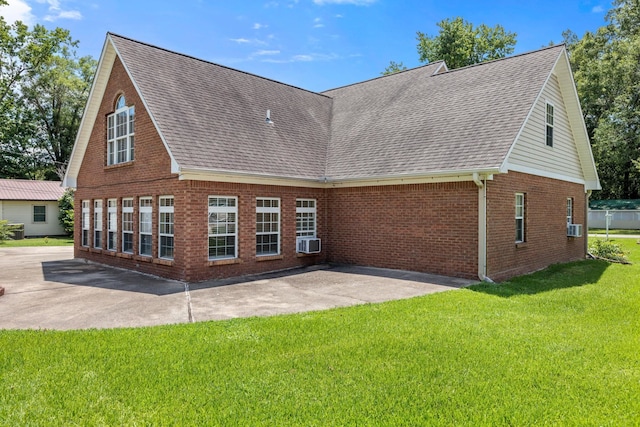 rear view of property with a patio area, a yard, and cooling unit