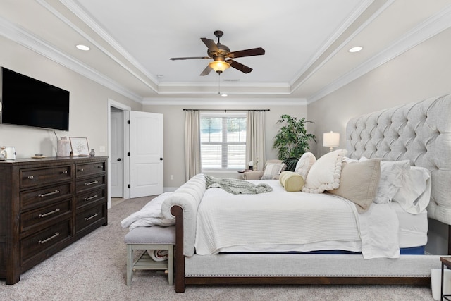 carpeted bedroom featuring crown molding, ceiling fan, and a tray ceiling