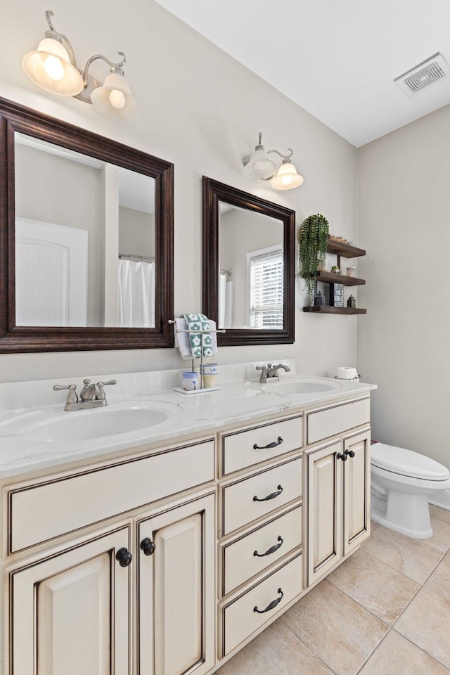 bathroom with vanity, toilet, and tile patterned flooring