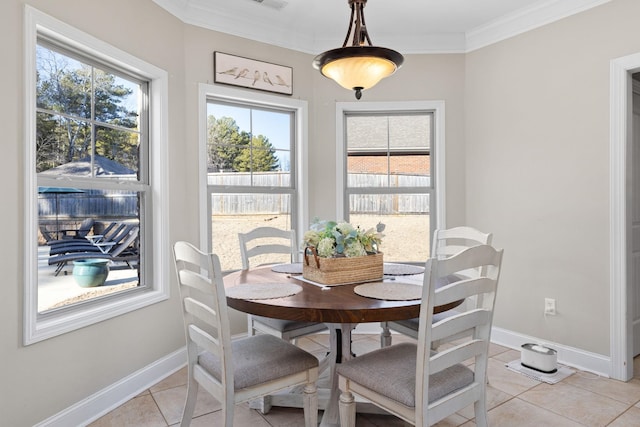 tiled dining space featuring ornamental molding