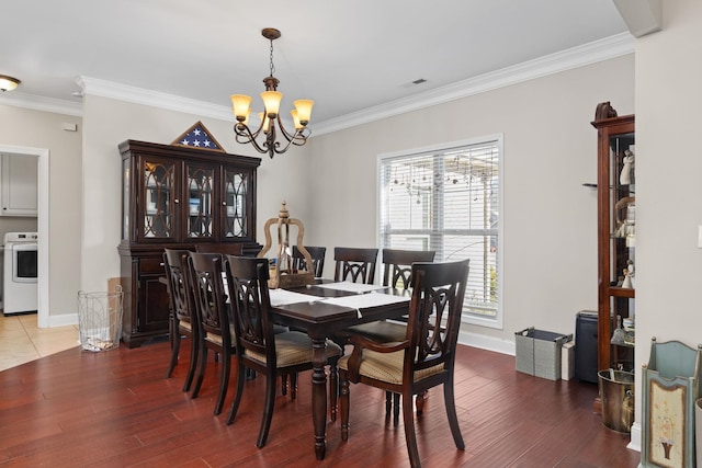 dining area featuring hardwood / wood-style flooring, ornamental molding, and a chandelier