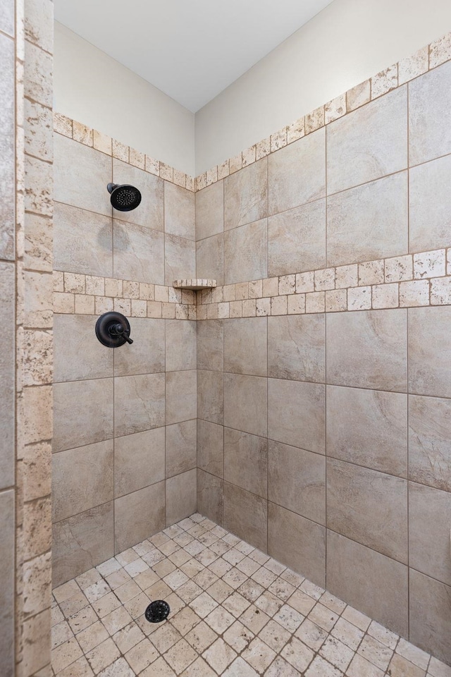 bathroom with tiled shower