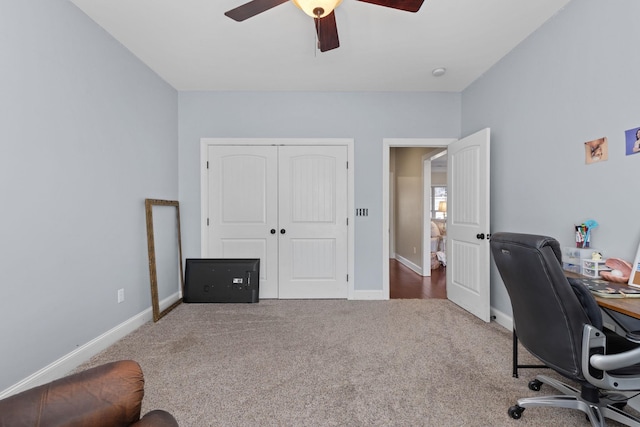 carpeted office featuring ceiling fan